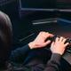 Hacker usa un teclado con las dos manos para atacar con rapidez