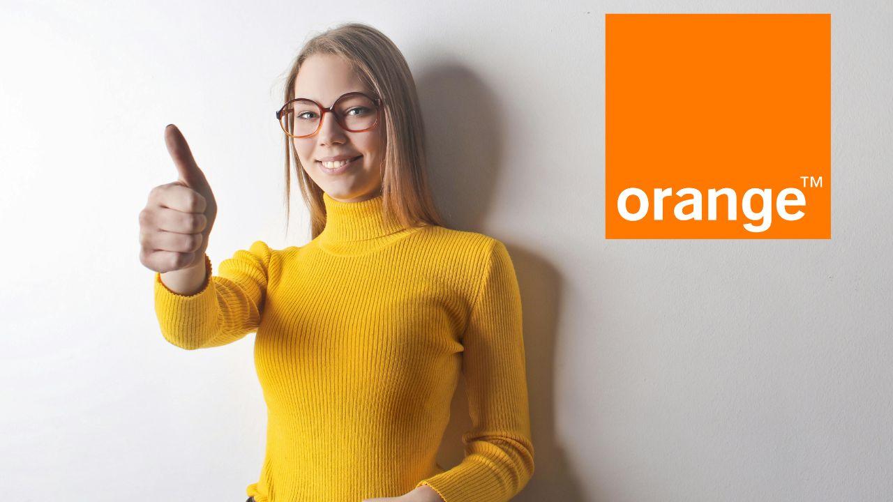 Chica levanta el pulgar dando su aprobación y se ve el logo de Orange