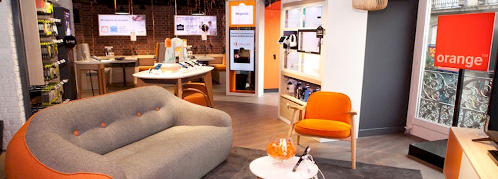 An orange store inside with sofa and chairs