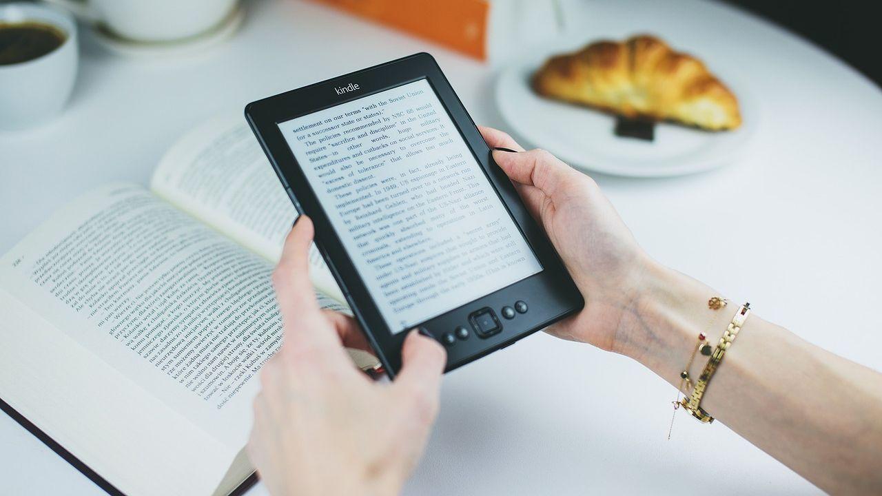 Holding a Kindle model with both hands
