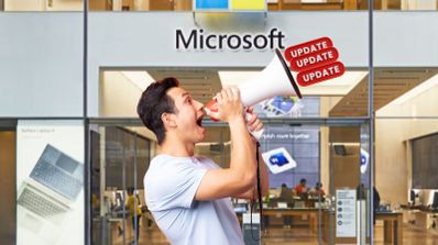 Un chico con un megáfono gritando actualizaciones en una tienda de Microsoft
