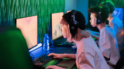 Una chica gamer disfrutando de una sesión de juego en un cibercafé