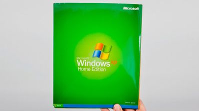 Caja original del software Microsoft Windows XP Professional, mostrando el logotipo y el diseño característico de 2001 sobre un fondo verde y azul.