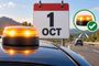 Luz de emergencia V16 encendida sobre el techo de un coche con un calendario al fondo marcando el 1 de octubre.