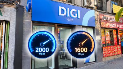 Fachada de una tienda DIGI store con dos iconos de velocímetros superpuestos que marcan 2000 Mbps y 1600 Mbps.