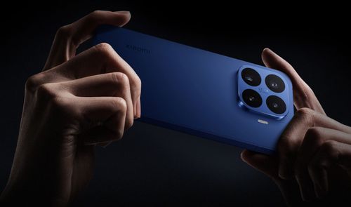 Parte trasera de un Xiaomi 17T azul sostenido horizontalmente, mostrando su módulo de cuatro cámaras cuadradas.
